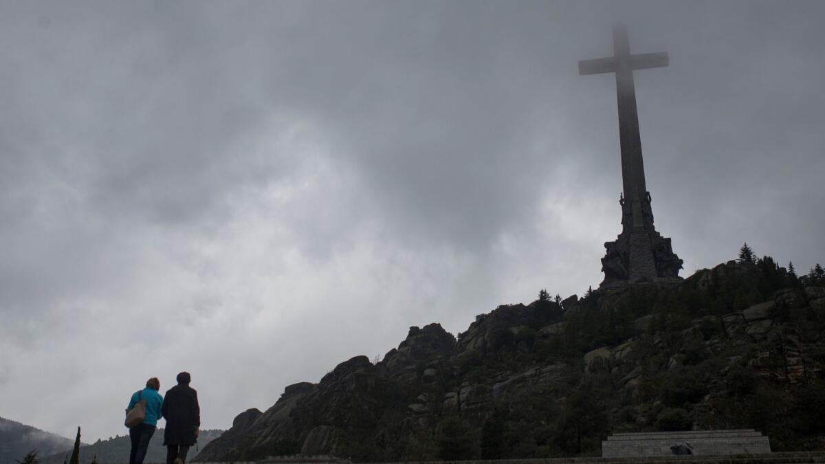 Tourists walk outside the Valley of the Fallen near Madrid.