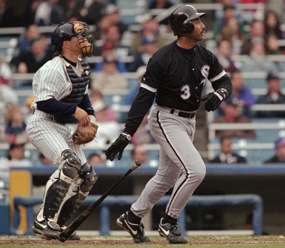 Harold Baines drops his bat as he and Yankees catcher Joe Girardi watch his grand slam leave the park at Yankee Stadium on May 4, 1996.
