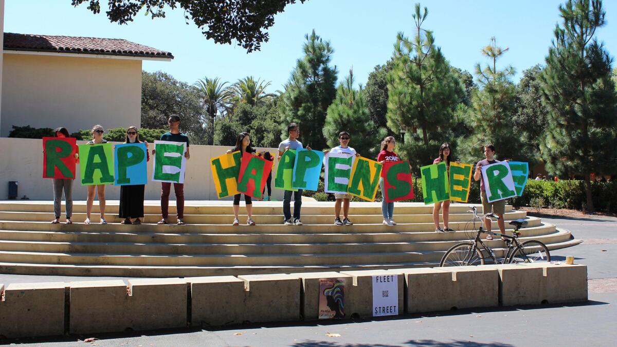 Students hold up a sign about rape at White Plaza during New Student Orientation on the Stanford University campus in Stanford, Calif.