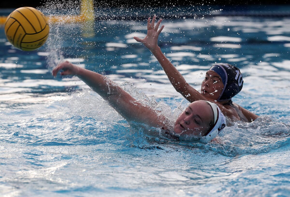 Laguna Beach's Charlotte Riches, bottom, scores against Newport Harbor's Caitlin Stayt during the first half Wednesay.