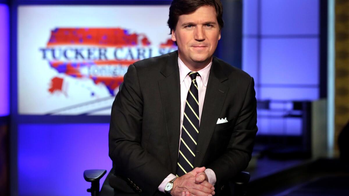 Tucker Carlson, host of "Tucker Carlson Tonight," poses in his Fox News Channel studio in New York in March.