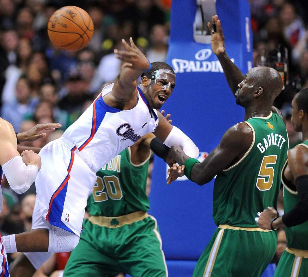 Clippers point guard Chris Paul draws a foul from Celtics power forward Kevin Garnett in the second half Monday night at Staples Center.