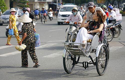 Tiffany Nguyen takes a cyclo from her apartment to work in Ho Chi Minh City, Vietnam. Nguyen, 28, is one of a growing number of Vietnamese Americans moving to the nation as it has emerged as one of the booming economies of Asia.