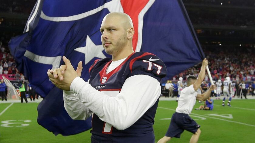 In this Oct. 9, 2014, file photo, Houston Texans tackle David Quessenberry, who was being treated for lymphoma, serves as honorary captain before an NFL football game in Houston.