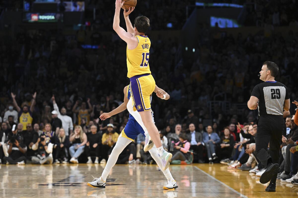 Lakers guard Austin Reaves shoots a buzzer-beater three-point shot to end the first half