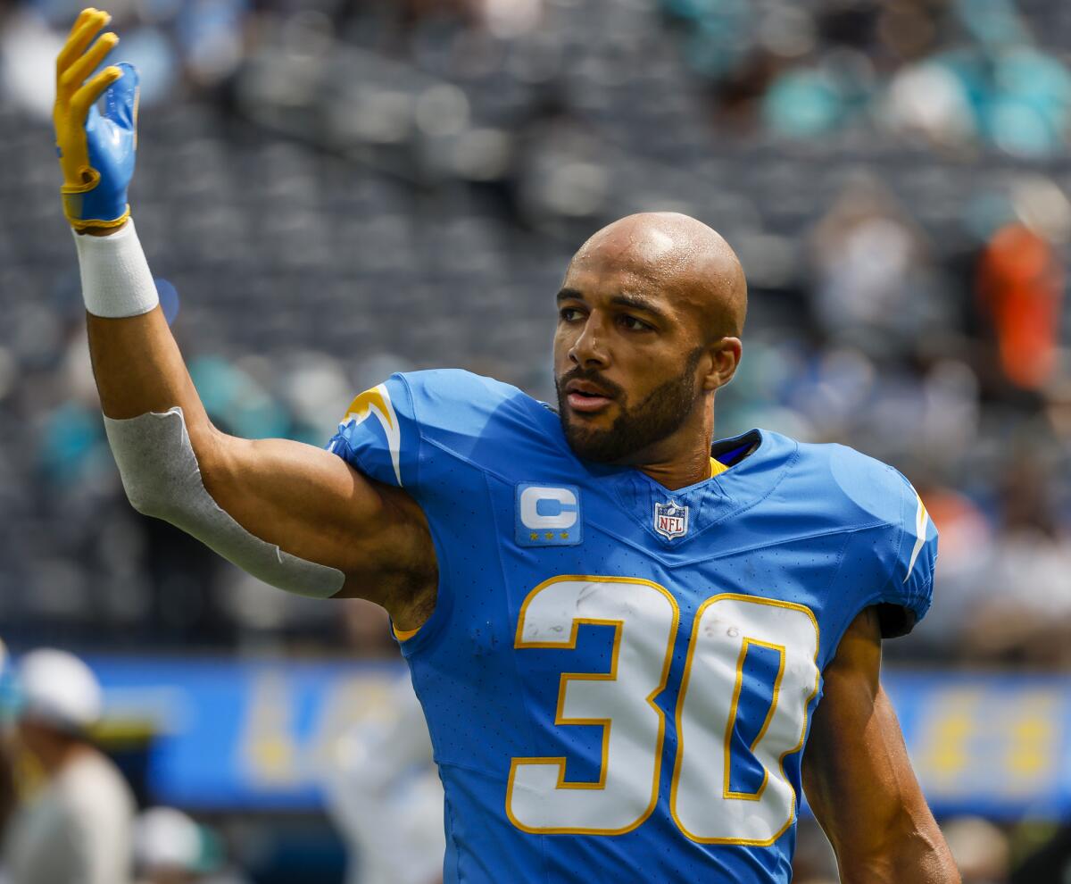 Chargers running back Austin Ekeler (30) calls teammates to the sideline before a game against the Miami Dolphins.