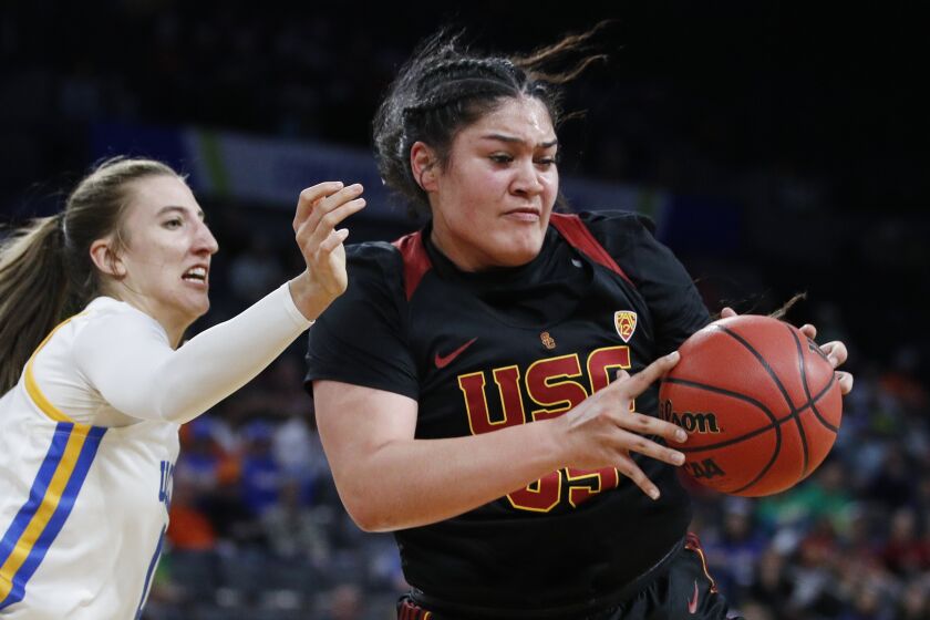 Southern California's Alissa Pili (35) drives around UCLA's Chantel Horvat (0) during.
