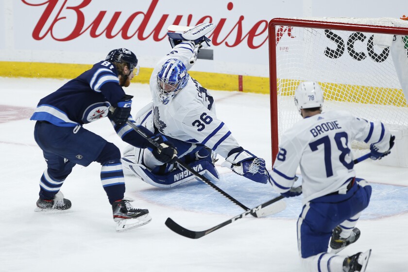 Winnipeg Jets' Kyle Connor (81) scores on Toronto Maple Leafs goaltender Jack Campbell (36) as TJ Brodie (78) defends during the second period of an NHL hockey game Friday, May 14, 2021, in Winnipeg, Manitoba. (John Woods/The Canadian Press via AP)