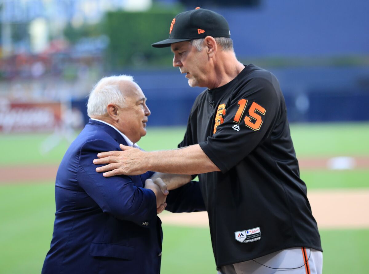Ron Fowler, now Padres vice chairman, congratulates then-Giants manager Bruce Bochy during a pregame ceremony in July 2019.
