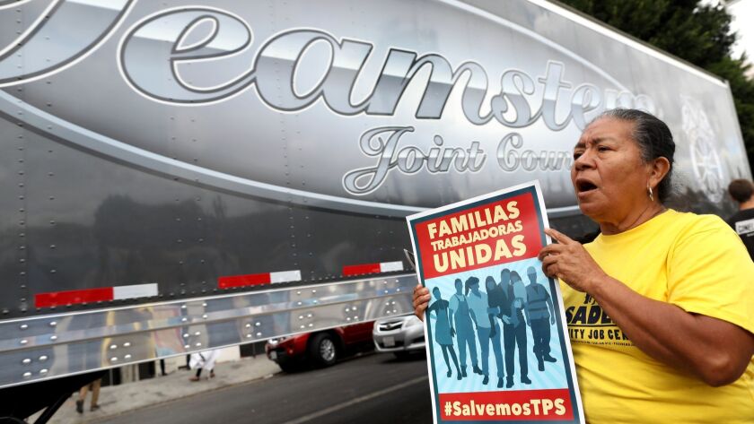 Cristina Felipe shows support at the Metropolitan Detention Center in Los Angeles for a convoy of half a dozen tractor-trailers driven by members of the Teamsters union in support of truck drivers and others threatened by deportation.