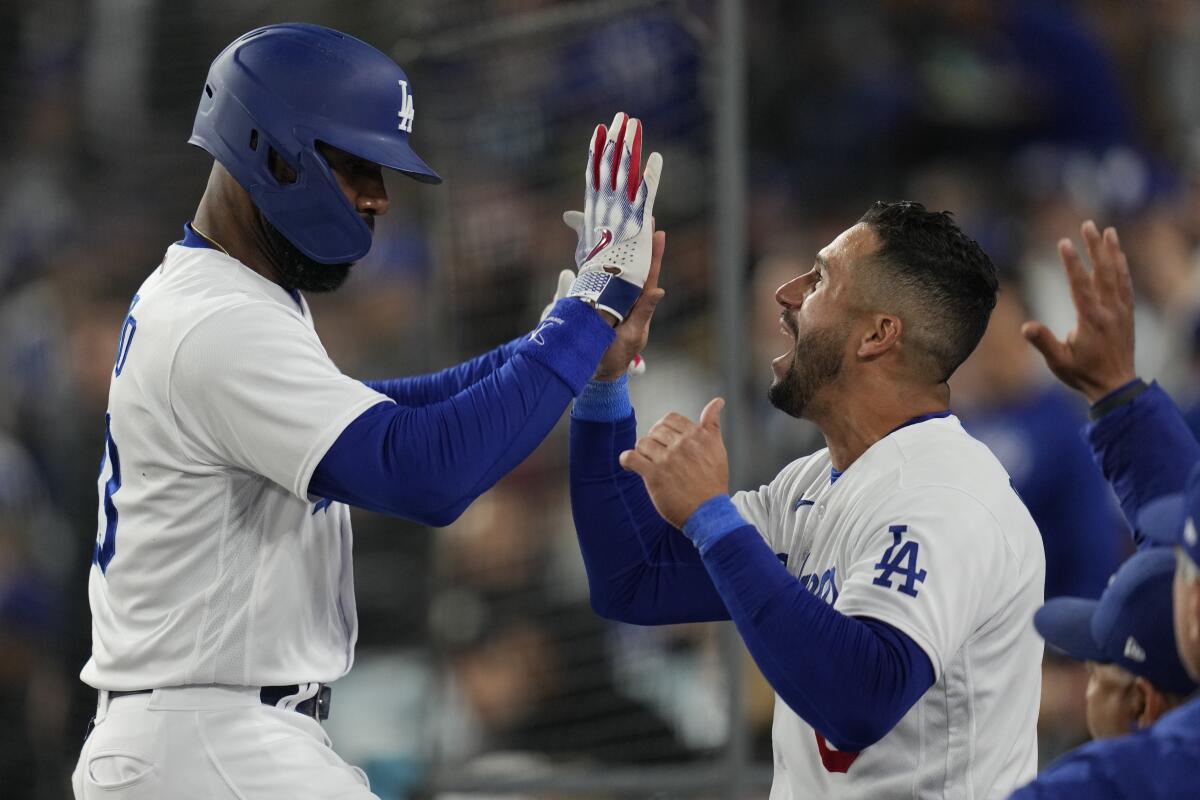 Jason Heyward, left, celebrates with Dodgers teammate David Peralta after hitting a home run.