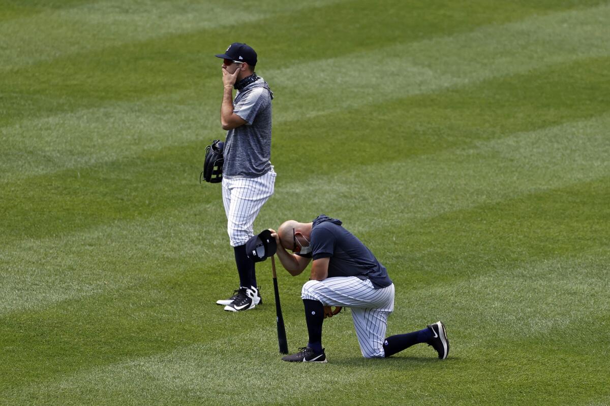 Yankees players react after Masahiro Tanaka was hit by a line drive during a workout July 4, 2020.