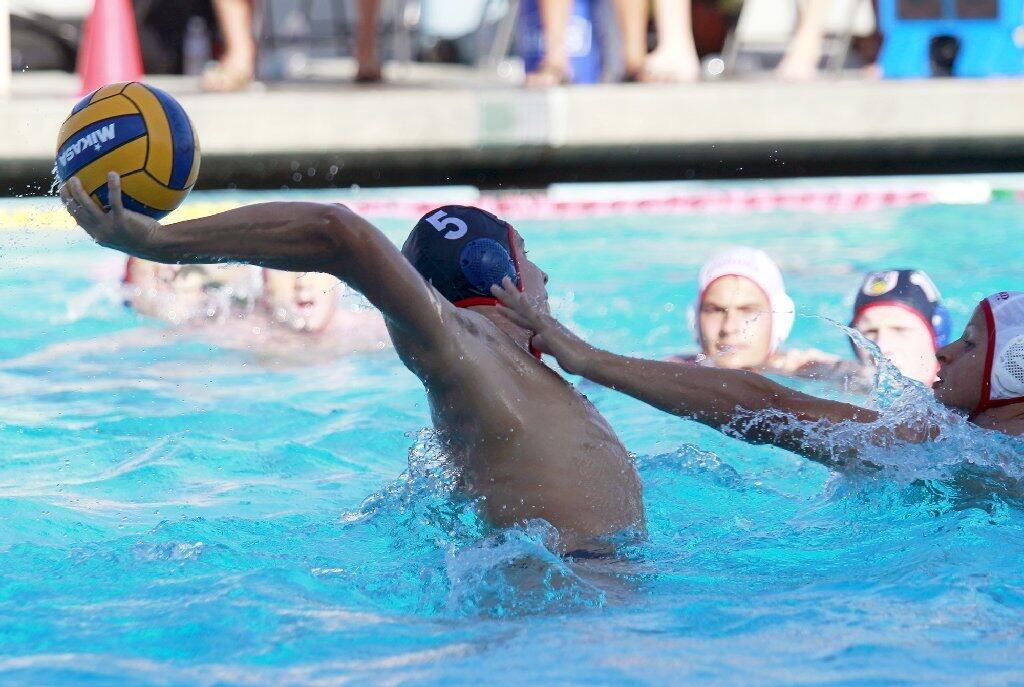 Regency Water Polo's Will Lapkin (5) scores under pressure during the second half against Stanford in the 2015 USA Junior Olympics 18U boys' bronze match at the William Woollett Aquatic Center in Irvine on Tuesday.