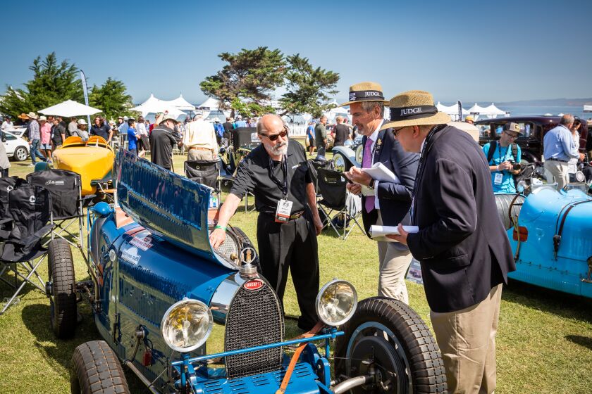 David Duthu of Coronado shows La Jolla Concours d'Elegance judges Harry Clerk and Jim Galvin his 1925 Bugatti Type 35A.