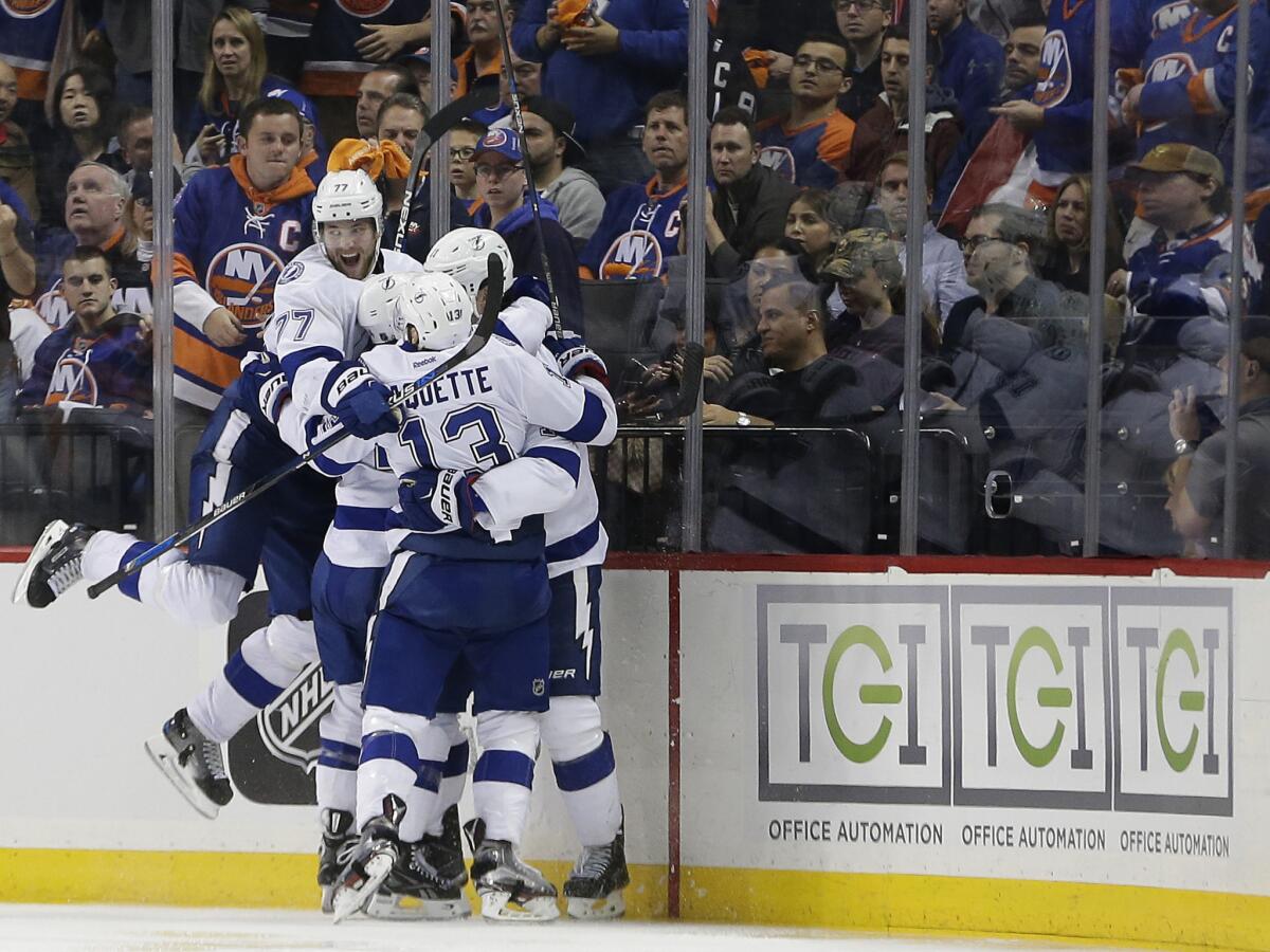 The Lightning celebrate a game-winning goal by forward Brian Boyle in overtime of Game 3 of the team's playoff series against the Islanders on May 3.