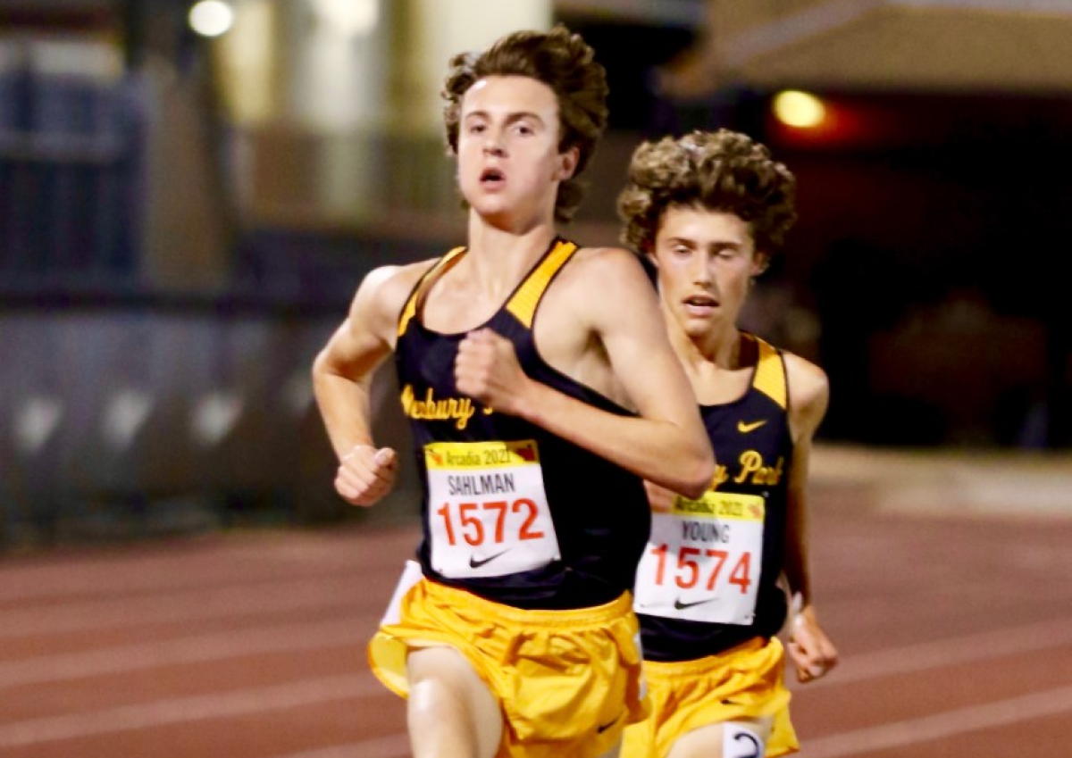 Newbury Park junior Colin Sahlman (left) sprints to the finish line pursued closely by sophomore teammate Lex Young.