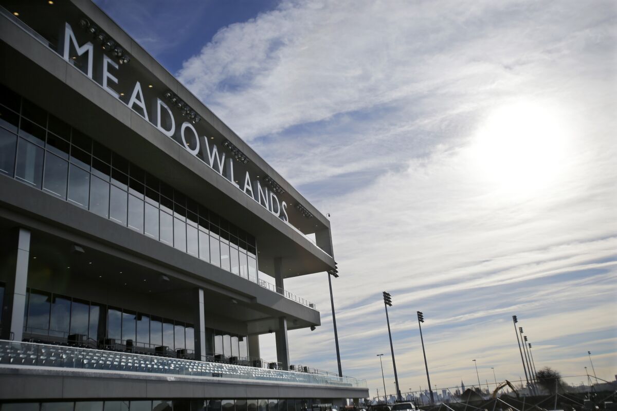 FILE - This Nov. 20, 2013 file photo shows the Meadowlands race track in East Rutherford, N.J. Two years after filing a first-of-its-kind lawsuit, an aggrieved harness-racing bettor has received $20,000 in the settlement of his claims that he was cheated out of his winnings when a doped horse won a race in New Jersey in 2016. The settlement was reached in July 2020. (AP Photo/Mel Evans, File)