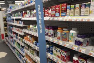 Vitamins are displayed in pharmacy Duane Reade by Walgreens, Thursday, March 25, 2021, in New York. Walgreens reports earnings March 31, 2021. (AP Photo/Mark Lennihan)