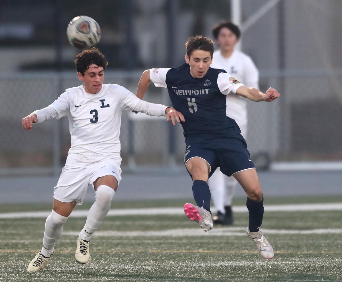 Newport Harbor's Jack Csergei (5) keeps a dribble away from Loyola's Dashel Petranek (3) on Friday.