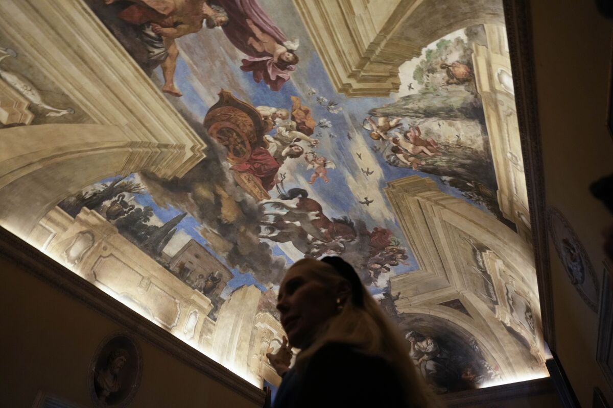 FILE - Princess Rita Boncompagni Ludovisi stands beneath a fresco by Italian Baroque painter Giovanni Francesco Barbieri, known as Guercino, inside The Casino dell'Aurora, also known as Villa Ludovisi, in Rome, Tuesday, Nov. 30, 2021. The villa containing the only known ceiling painted by Caravaggio goes on the court-ordered auction block Tuesday, Jan. 18, 2022 with an estimated value of nearly a half-billion euros (dollars), thanks to an inheritance dispute pitting the heirs of one of Rome’s aristocratic families against their step-mother, a Texas-born princess. (AP Photo/Gregorio Borgia, File)