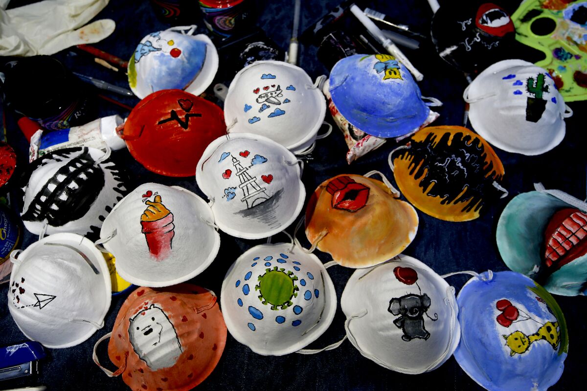 N95 masks painted by Palestinian artists Samah Saed and Dorgam Krakeh for a COVID-19 awareness project.