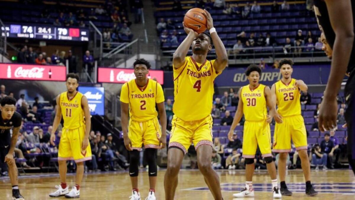 USC forward Chimezie Metu (4) shoots a free throw against Washington as teammates, from left, Jordan McLaughlin (11), Jonah Mathews (2), Elijah Stewart (30) and Bennie Boatwright (25) look on during a game last season. All five are returning to the team.