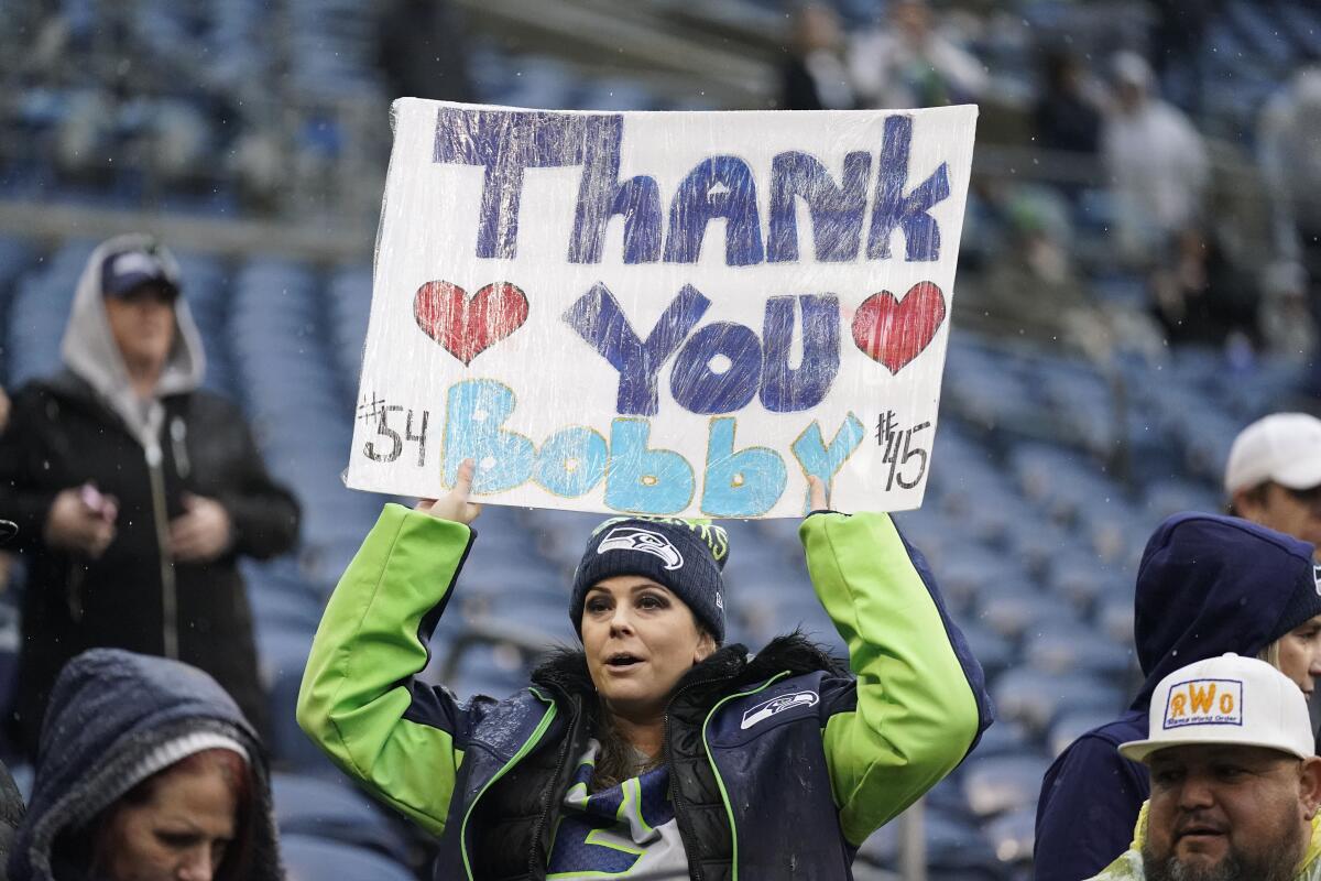 A Seattle Seahawks fan holds a sign for Rams linebacker Bobby Wagner.