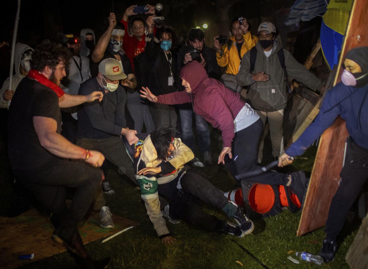 Demonstrators clash at an encampment at UCLA.