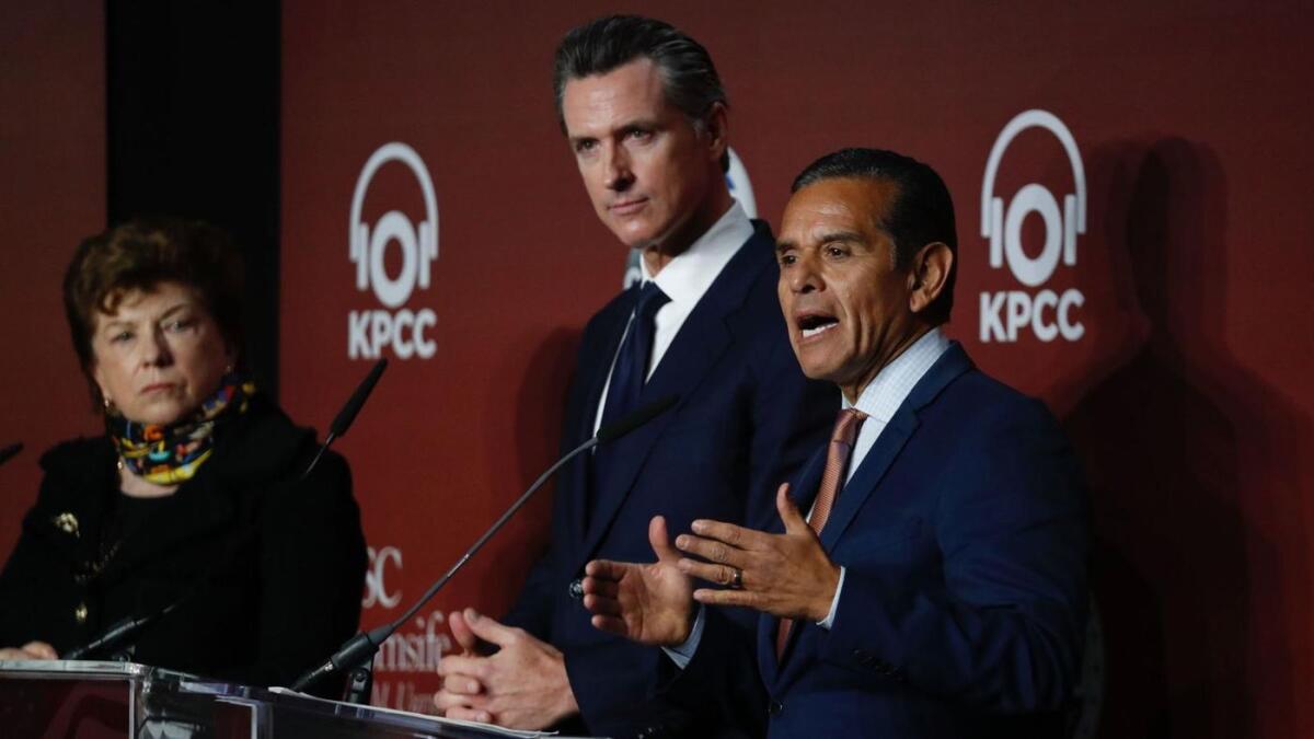 Delaine Eastin, left, Lt. Gov. Gavin Newsom listen as former L.A. Mayor Antonio Villaraigosa speaks during a gubernatorial debate.