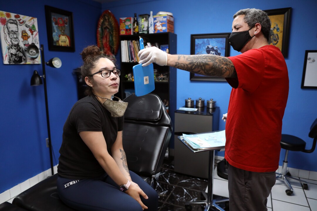 Genesis Nieves gets ready for a nose piercing in Yuba City.