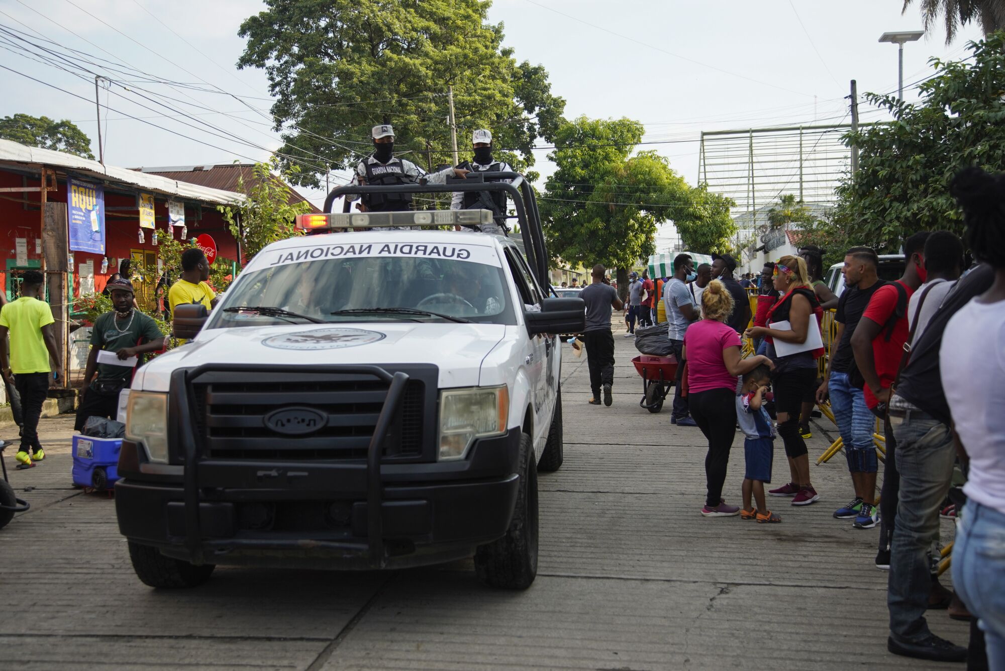 Mexican National Guard patrol the street outside one of the asylum offices in Tapachula