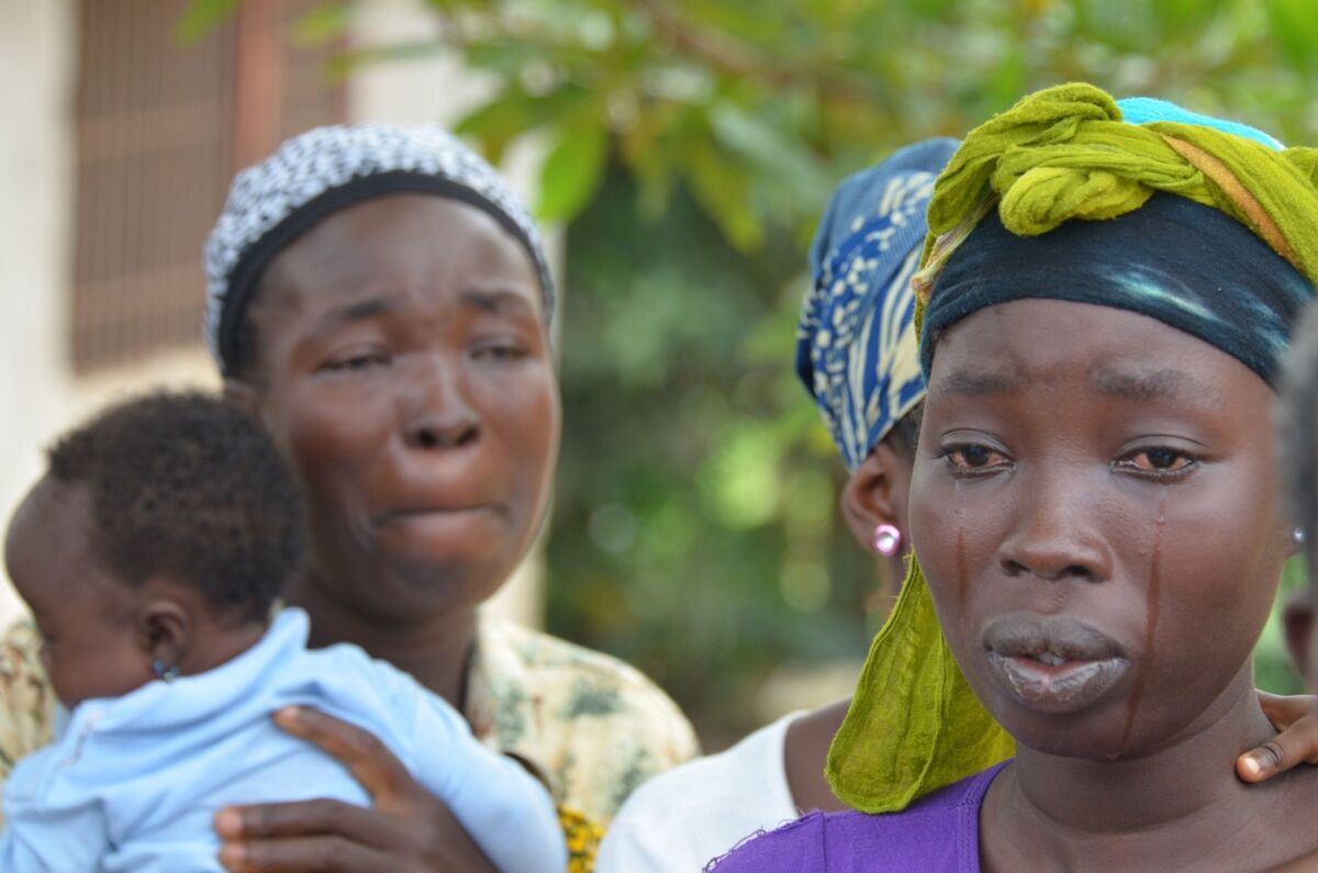 A woman cries over the death of her husband, a victim of the Ebola virus in Monrovia, Liberia.