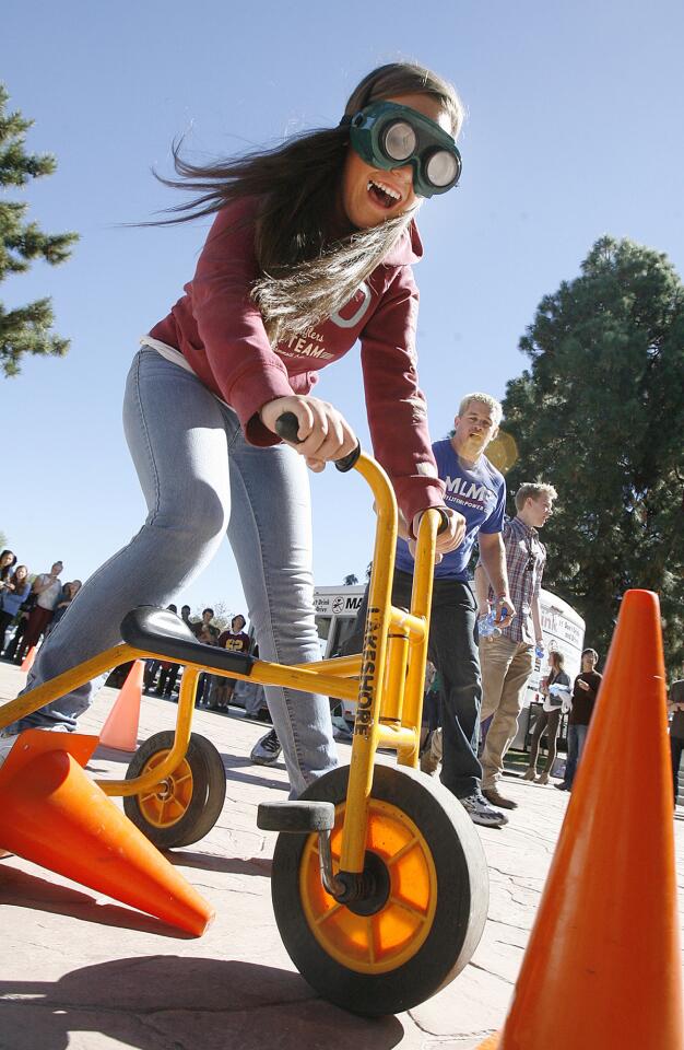 Student Brittani Van Stoy, 14, wears vision distorting glasses to push a tricycle through a cone course at La Canada High School to simulate driving while intoxicated on Thursday, October 25, 2012.