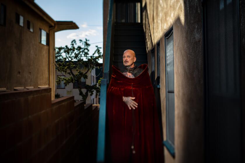 LOS ANGELES, CA --MARCH 27, 2020 -Performance artist Ron Athey, whose work has touched on politics, myth, queerness and the body, is photographed wearing a gown that once belonged to the late Australian-born performance artist Leigh Bowery, in the Silver Lake neighborhood of Los Angeles, CA, March 27, 2020, and is one of many L.A. artists dealing with the coronavirus pandemic and trying to keep creating as restrictions on daily life have increased. Athey is using the quarantine time to work on a retrospective that is currently scheduled to open in the fall at Participant Inc. in New York City, and will later travel to the Institute of Contemporary Art, Los Angeles.(Jay L. Clendenin / Los Angeles Times)