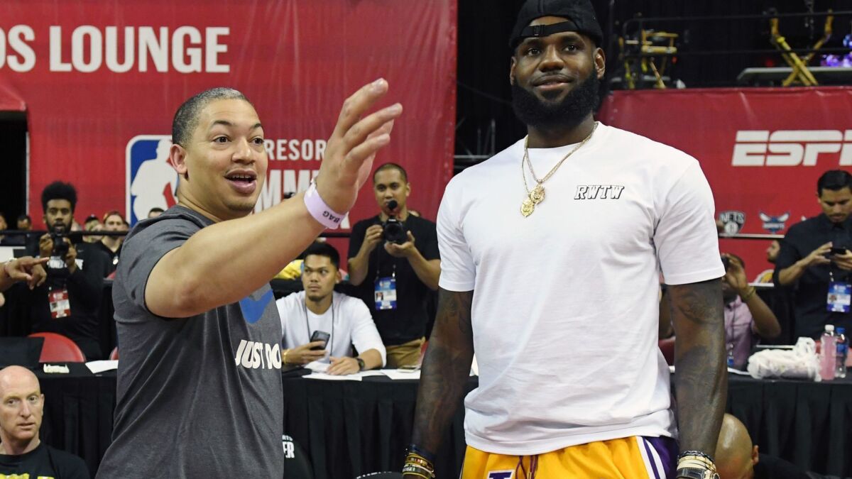 Tyronn Lue and LeBron James chat during a game at the 2018 Las Vegas Summer League tournament.