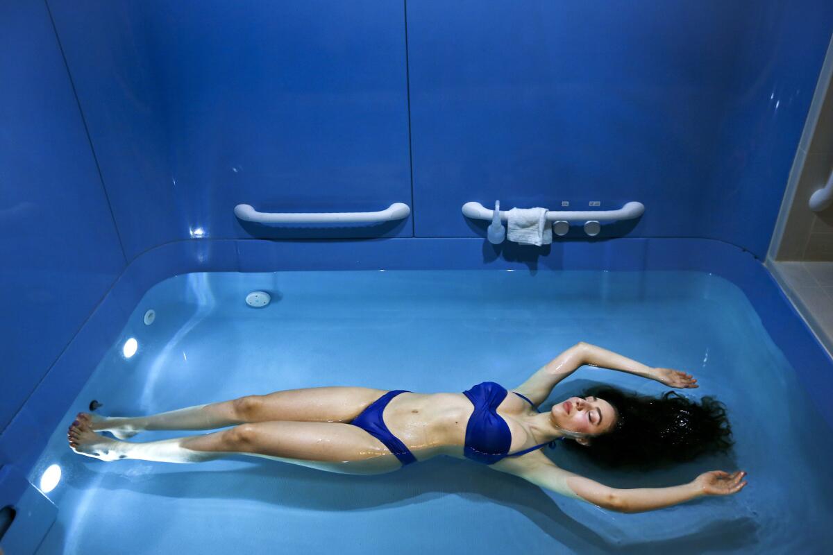 Ilona Houhanissyan, an employee at Just Float in Pasadena, demonstates floating with no effort inside of a float cabin.