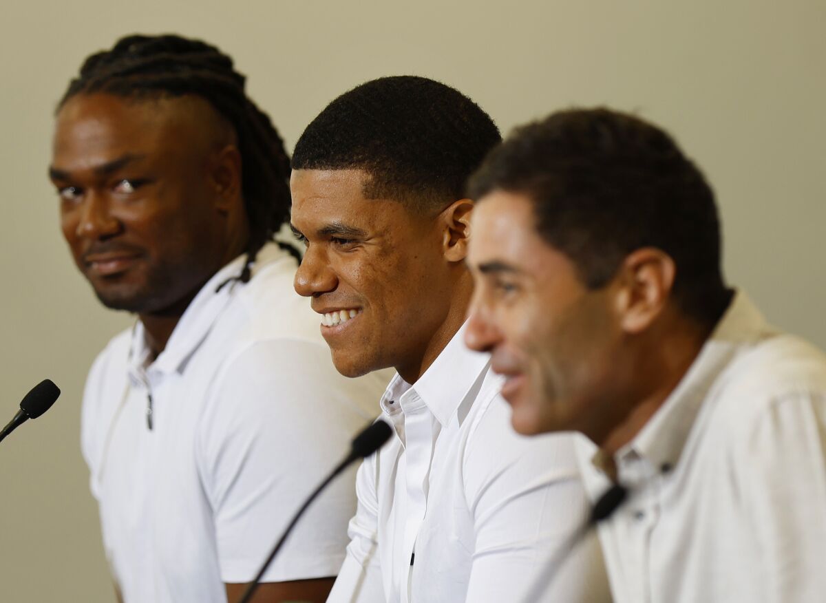 New Padres Josh Bell (left) and Juan Soto at a news conference last week with A.J. Preller.