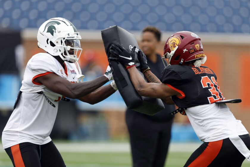 National receiver Jayden Reed of Michigan State (1) and cornerback Mekhi Blackmon of USC (31) run through drills during practice for the Senior Bowl NCAA college football game Wednesday, Feb. 1, 2023, in Mobile, Ala.. (AP Photo/Butch Dill)