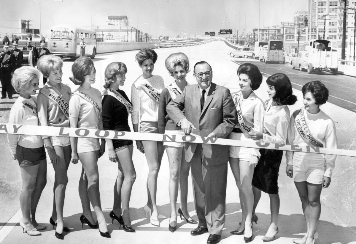 Gov. Pat Brown at a 1962 ribbon-cutting ceremony opening a section of the Santa Monica Freeway. Helping him are girls representing many freeways around Los Angeles.