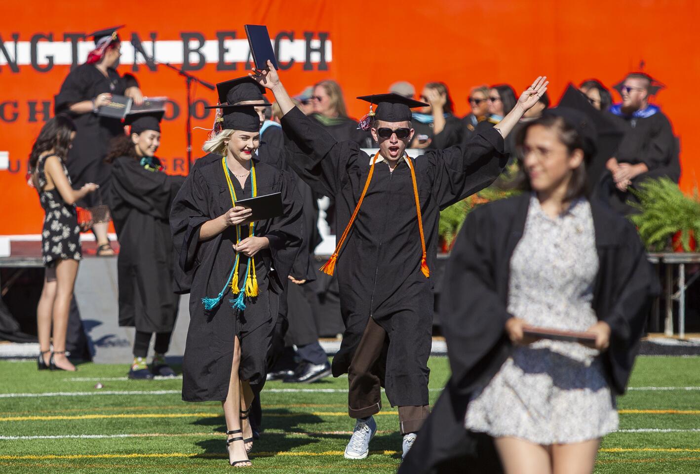 Lola Trifunovic, left, and Damian Kassoff celebrate during the commencement ceremony for the Huntington Beach High School class of 2018 on Wednesday, June 13.