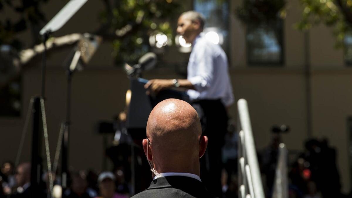 A Secret Service agent watches as President Obama speaks at Los Angeles Trade Technical College in July. A man in the audience yelled that Obama was the Antichrist.