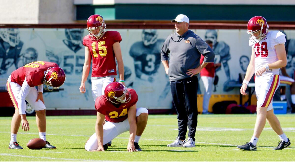 USC coach Clay Helton watches kickers Michael Brown (49), Thomas Fitts (15) and Alex Stadthaus (38) and punter Ben Griffiths (24) at spring pracitce.