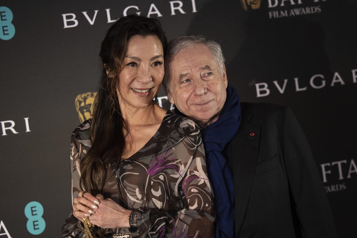 Michelle Yeoh and Jean Todt pose for photographers at the BAFTA awards.