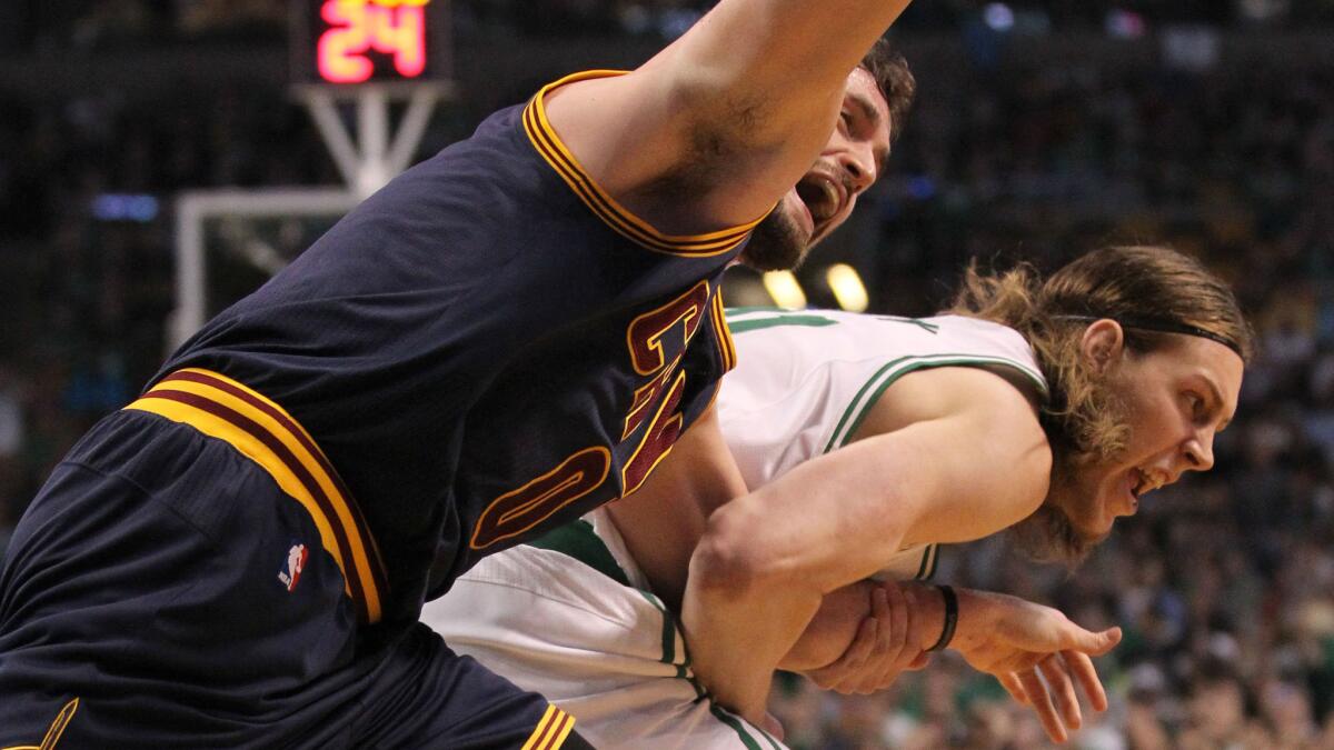 Cleveland Cavaliers forward Kevin Love, left, and Boston Celtics center Kelly Olynyk tangle while chasing after a loose ball during the first quarter of the Cavaliers' 101-93 win in Game 4 of the Eastern Conference quarterfinals on April 26.