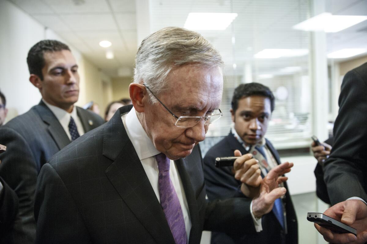 Senate Majority Leader Harry Reid is surrounded by reporters after talking about the final work of the Senate for the year at the Capitol in Washington, D.C., on Thursday.