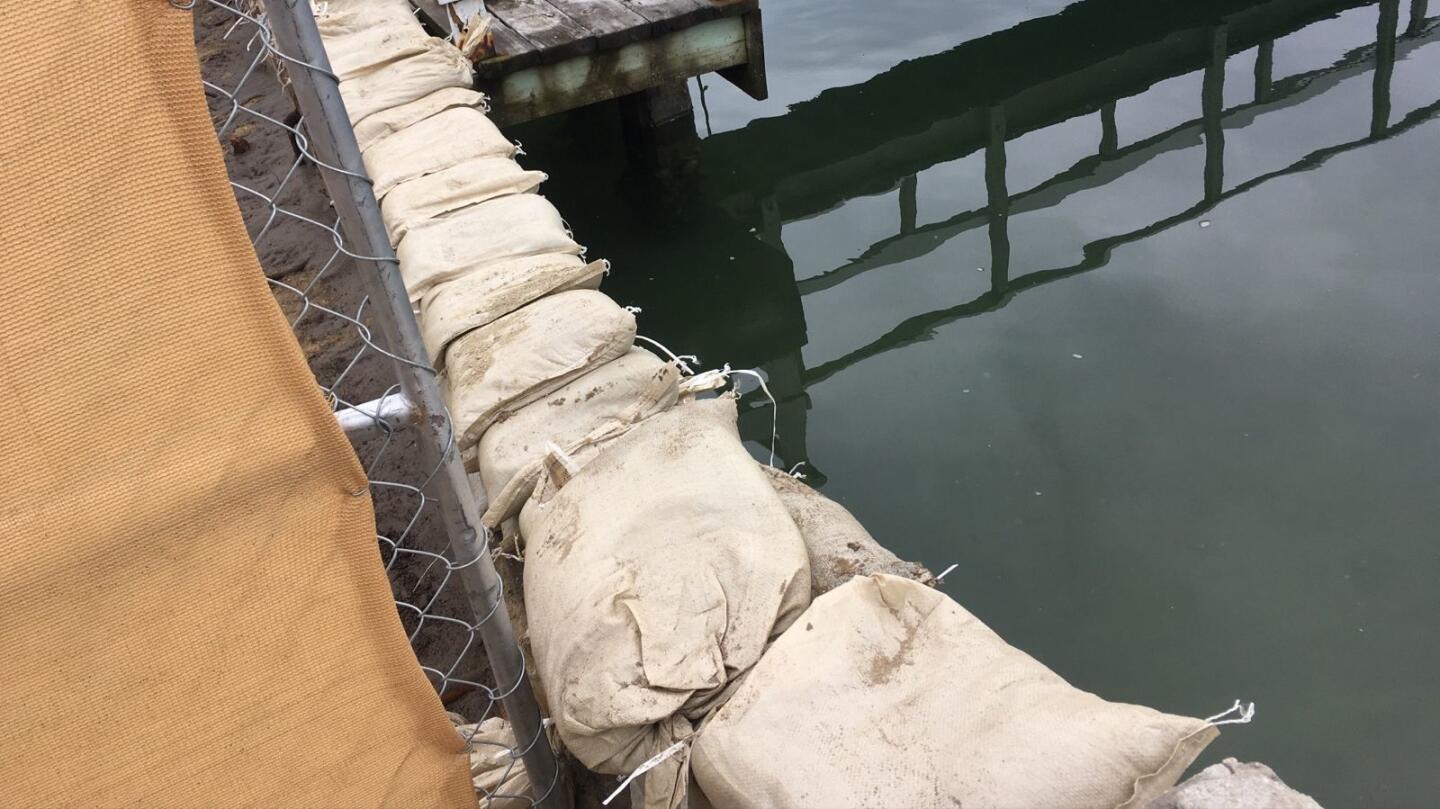 Sandbags are placed where a private seawall cap used to be near 36th Street in Newport Beach. The city says a demolition crew clearing a lot took out the wall cap.