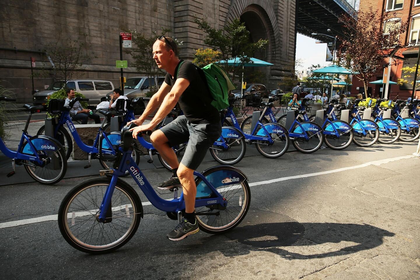A man rides a shared bike rented through the Citi Bike program in Brooklyn, N.Y., on Oct. 4. The program was beset by mechanical problems and overwhelmed by demand when it launched in May, but it has apparently righted itself since then.
