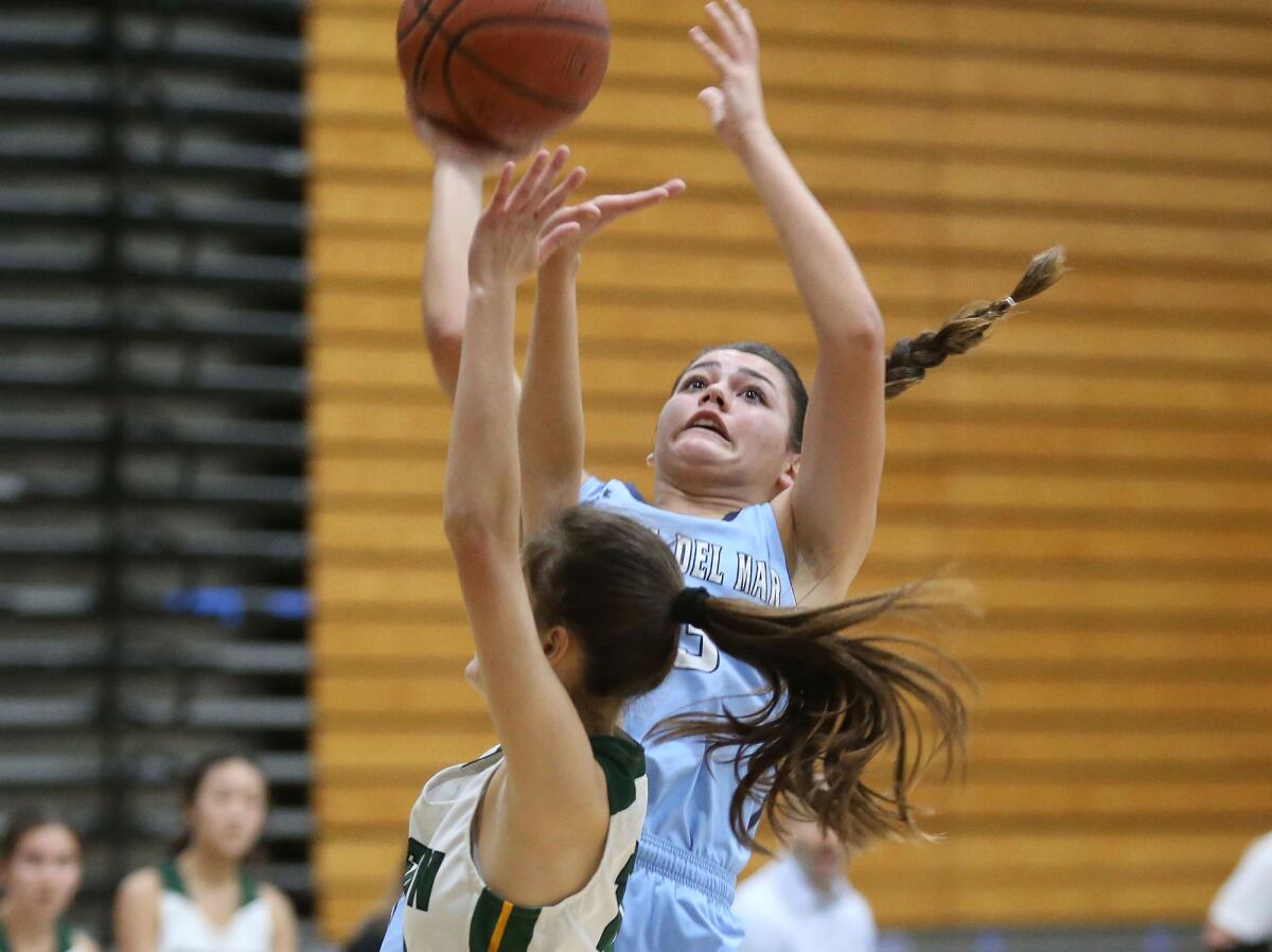 Corona del Mar's Trasara Alexander drives in for a layup during a Surf League game at Edison on Thursday.