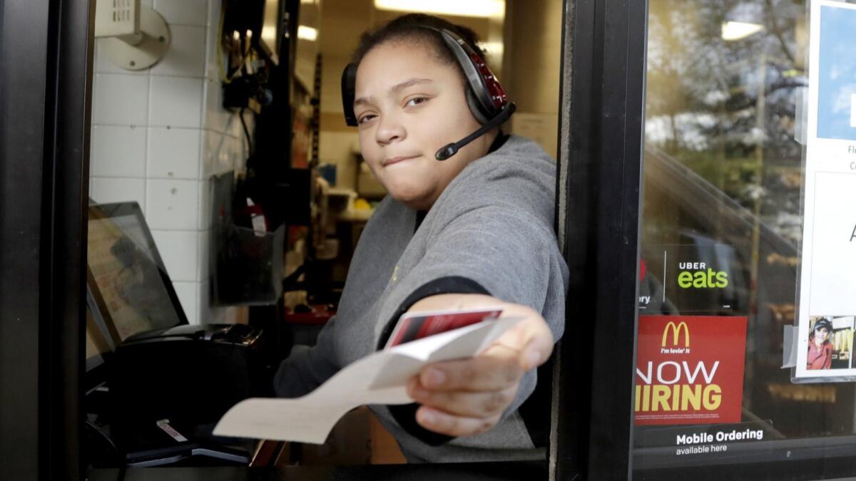 A cashier returns a credit card and a receipt at a McDonald's window in Atlantic Highlands, N.J. on Jan. 3.