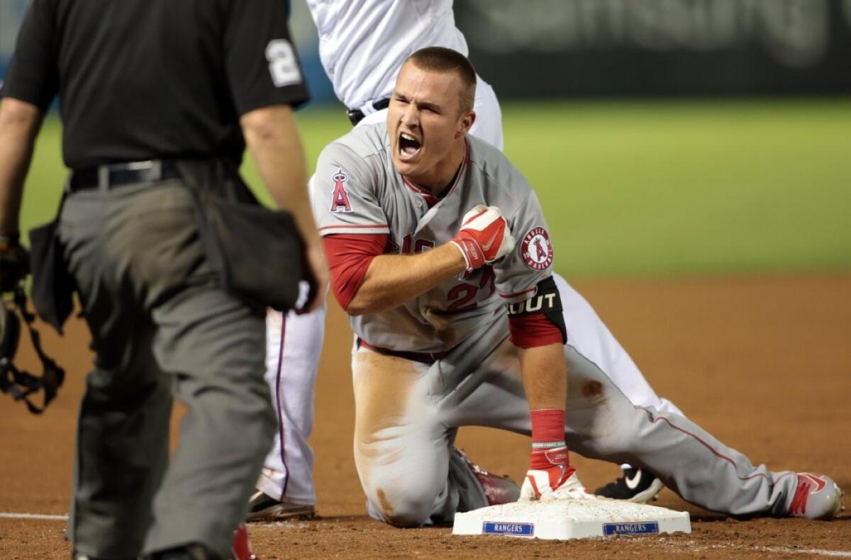 Angels outfielder Mike Trout reacts after hitting a triple during the ninth inning of a game against the Texas Rangers on Oct. 2.